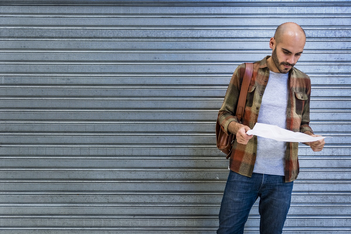 man reading a garage door opener's manual