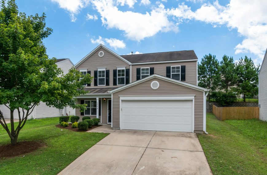 two-story house with a white garage door