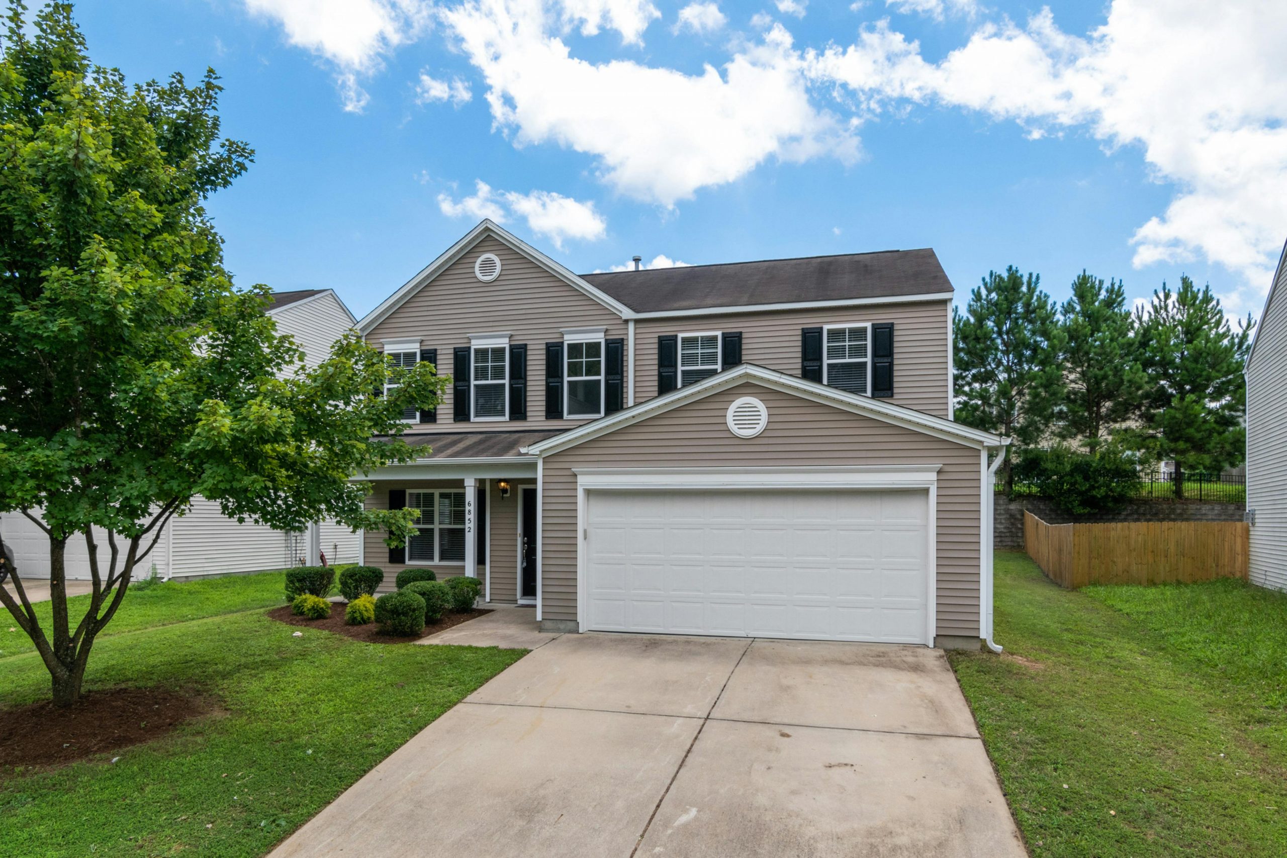 two-story house with a white garage door