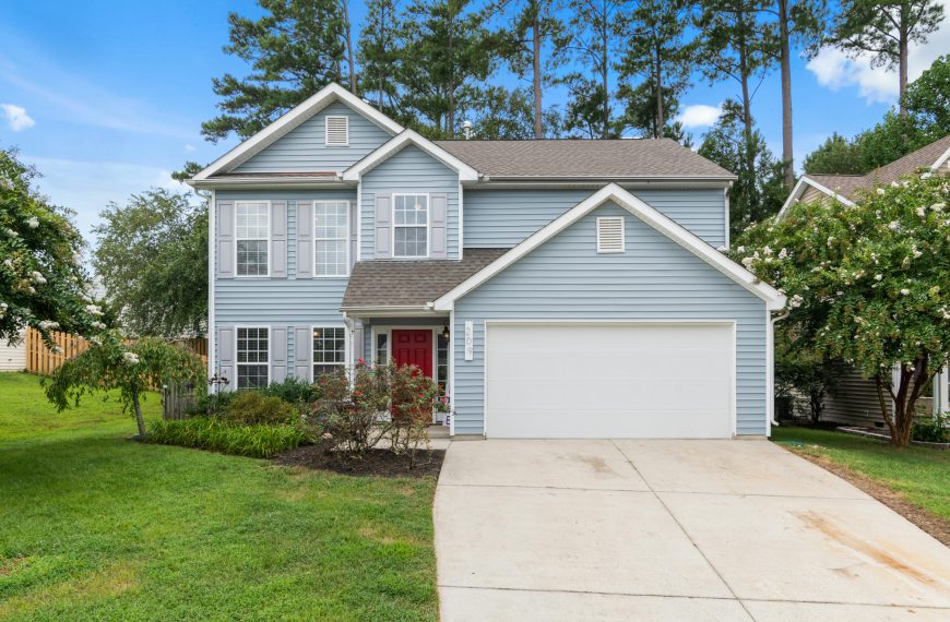 blue house with a white garage door