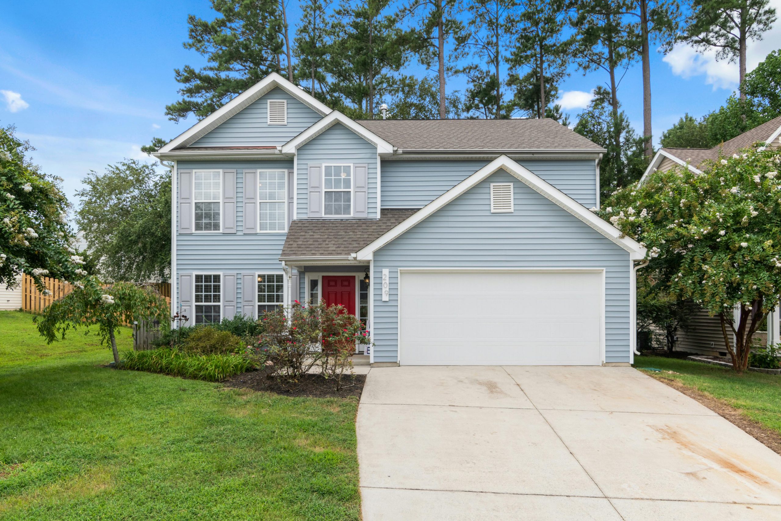 blue house with a white garage door